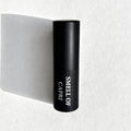Smell of Capri Eau de Parfum by Essenzia, faceted black bottle with gold label and smoked crystal base
